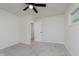 Carpeted bedroom featuring a ceiling fan and an open doorway at 8115 Englewood Rd, Indianapolis, IN 46240