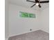 Carpeted bedroom featuring a ceiling fan and a window at 8115 Englewood Rd, Indianapolis, IN 46240