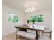 Bright dining room featuring a large window, a spacious table, modern seating, and lots of natural light at 8115 Englewood Rd, Indianapolis, IN 46240
