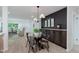 Inviting dining room with a glass table, modern chairs, and stylish built-in cabinets adjacent to the living room at 8115 Englewood Rd, Indianapolis, IN 46240