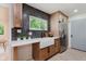 Modern kitchen design showcasing gray herringbone backsplash, stainless appliances, farm sink, and wood cabinets at 8115 Englewood Rd, Indianapolis, IN 46240