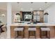 Modern kitchen features a large island, herringbone backsplash, stainless steel appliances, and pendant lighting at 8115 Englewood Rd, Indianapolis, IN 46240
