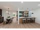 Stylish kitchen and dining area with modern lighting, stainless steel appliances, and island seating at 8115 Englewood Rd, Indianapolis, IN 46240