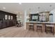 Bright kitchen and dining area with modern appliances, a breakfast bar, and a dark accent wall in the adjacent dining space at 8115 Englewood Rd, Indianapolis, IN 46240