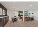 Open-concept kitchen and dining area featuring stainless steel appliances, island seating, and adjacent dining nook with stylish decor at 8115 Englewood Rd, Indianapolis, IN 46240
