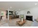 Spacious living room features an open layout to the kitchen, stylish fireplace, and hardwood flooring at 8115 Englewood Rd, Indianapolis, IN 46240