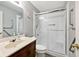 A bathroom with a sliding glass shower door, grab bars, vanity, and toilet at 8247 Cape N Dr, Indianapolis, IN 46256