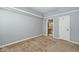 A carpeted bedroom features neutral walls, white trim, and a door leading to the bathroom at 8247 Cape N Dr, Indianapolis, IN 46256
