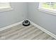 View of room featuring wood-look floors, white trim, and a sunny window at 8247 Cape N Dr, Indianapolis, IN 46256