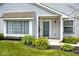 Home featuring a covered front porch, an upgraded door, and charming landscaping at 8247 Cape N Dr, Indianapolis, IN 46256