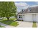 Charming home featuring an attached garage and a beautifully landscaped yard with mature trees at 8247 Cape N Dr, Indianapolis, IN 46256