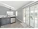 Contemporary kitchen with stainless steel dishwasher and sliding glass doors to sunroom at 8247 Cape N Dr, Indianapolis, IN 46256