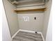 Empty laundry room with wood-look flooring and stacked shelving ready for appliances at 8247 Cape N Dr, Indianapolis, IN 46256