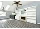 Open-concept living space featuring built-in shelving, fireplace, and bar seating at 8247 Cape N Dr, Indianapolis, IN 46256