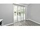 View of sunroom through sliding glass door from kitchen, with wood-look flooring at 8247 Cape N Dr, Indianapolis, IN 46256