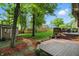 A spacious backyard featuring a shed, wooden fence, and deck with outdoor furniture at 8313 Tequista Cir, Indianapolis, IN 46236