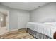 Cozy bedroom with lots of light, light colored walls, and wood-look flooring at 8313 Tequista Cir, Indianapolis, IN 46236