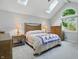Bright bedroom with vaulted ceiling, skylights, large window, and a cozy rug at 8313 Tequista Cir, Indianapolis, IN 46236
