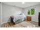 Cozy bedroom with lots of light, light colored walls, and wood-look flooring at 8313 Tequista Cir, Indianapolis, IN 46236