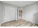 Bright bedroom featuring hardwood floors and a closet with double doors at 8313 Tequista Cir, Indianapolis, IN 46236