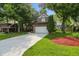 Inviting home with a well-kept lawn and mature trees, showcasing an attached two-car garage at 8313 Tequista Cir, Indianapolis, IN 46236