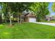 Beautiful two-story home featuring an attached garage, lush green lawn, and mature trees in a well-maintained yard at 8313 Tequista Cir, Indianapolis, IN 46236