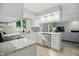 Bright kitchen features white cabinetry, stainless steel appliances, and breakfast bar with granite countertops at 8313 Tequista Cir, Indianapolis, IN 46236