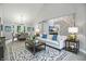 Bright living room featuring modern furnishings, a patterned rug, and an open dining area at 8313 Tequista Cir, Indianapolis, IN 46236