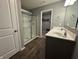 Bathroom featuring a double sink vanity, modern fixtures, and a glass enclosed shower at 8969 Faulkner Dr, Indianapolis, IN 46239
