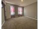 Neutral-colored bedroom featuring carpet floors, two windows with curtains, and gray-painted walls at 8969 Faulkner Dr, Indianapolis, IN 46239