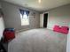 Bedroom featuring a large window for natural light, neutral walls, and plush carpet at 8969 Faulkner Dr, Indianapolis, IN 46239