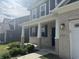 Inviting front porch with white columns, brick accents, and a dark-colored front door at 8969 Faulkner Dr, Indianapolis, IN 46239