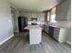 Open kitchen with gray cabinets, granite counters, stainless appliances, and a large island at 8969 Faulkner Dr, Indianapolis, IN 46239