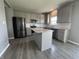 Bright kitchen features gray cabinetry, an island with granite countertops, and stainless appliances at 8969 Faulkner Dr, Indianapolis, IN 46239
