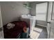 Laundry room with white washer and dryer, overhead shelving, and a window at 8969 Faulkner Dr, Indianapolis, IN 46239