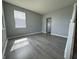 Bright living room with gray walls and wood-look floors, complemented by natural light at 8969 Faulkner Dr, Indianapolis, IN 46239