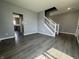 Spacious living room with hardwood floors, neutral paint, and a staircase at 8969 Faulkner Dr, Indianapolis, IN 46239