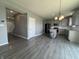 Open-concept living and kitchen area with gray walls and wood flooring at 8969 Faulkner Dr, Indianapolis, IN 46239