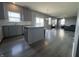 Open-concept living space with an island kitchen, hardwood floors, and ample natural light at 8969 Faulkner Dr, Indianapolis, IN 46239