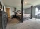 Spacious main bedroom featuring a carpeted floor and a four-post bed frame at 8969 Faulkner Dr, Indianapolis, IN 46239