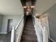 Carpeted staircase with white railing leading to the upper level of the home at 8969 Faulkner Dr, Indianapolis, IN 46239