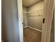 A view into the walk-in closet that features installed shelving and carpeted flooring at 8969 Faulkner Dr, Indianapolis, IN 46239