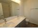 Bathroom featuring double sinks, a large mirror, and modern fixtures at 9516 Bauhaus Way, Indianapolis, IN 46240