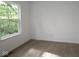 Bright bedroom with large window, neutral paint, and neutral carpet flooring throughout at 9516 Bauhaus Way, Indianapolis, IN 46240