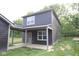 Modern two-story home with a dark gray exterior, back patio, and well-maintained lawn at 9516 Bauhaus Way, Indianapolis, IN 46240