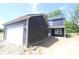 Exterior shot of modern home, with attached garage, and gray siding with white trim at 9516 Bauhaus Way, Indianapolis, IN 46240