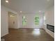 Open-concept living room with hardwood floors, natural light, fireplace, and neutral paint at 9516 Bauhaus Way, Indianapolis, IN 46240