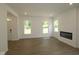 Bright living room featuring hardwood floors and a modern fireplace at 9516 Bauhaus Way, Indianapolis, IN 46240