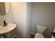 Modern half bathroom with pedestal sink and toilet at 9520 Bauhaus Way, Indianapolis, IN 46240
