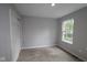 Neutral bedroom features a window offering natural light and closet with sliding doors at 9520 Bauhaus Way, Indianapolis, IN 46240